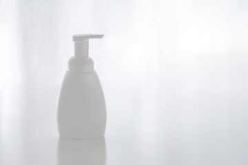 Fototapeta na wymiar Organic natural cosmetic for baby, plastic bottle of bath cream, shampoo, lotion, shower gel, body milk on white background. Mockup, copy space