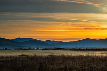 Sunrise on mountain with colorful skyline and fog Near the Drvar in Bosnia and Herzegovina