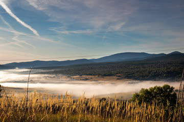 Sunrise on mountain with colorful skyline and fog Near the Drvar in Bosnia and Herzegovina