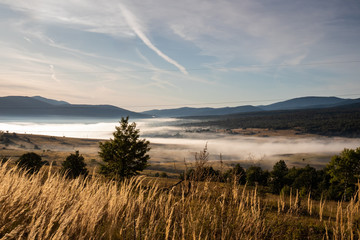 Sunrise on mountain with colorful skyline and fog Near the Drvar in Bosnia and Herzegovina