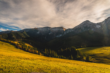 Obraz premium High rocky mountains against the background of the setting sun. Zdiar in Slovakia, high Bielanske Tatras. Trip to the mountains, climbing, hiking in the mountains. Tourists in the mountains.