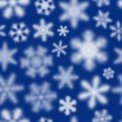 Fototapeta na wymiar Christmas seamless pattern of white defocused snowflakes on blue background