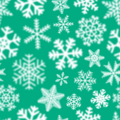 Fototapeta na wymiar Christmas seamless pattern of white defocused snowflakes on turquoise background