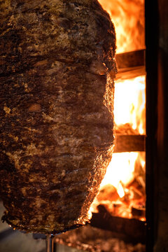 Close up shot of stacked meat roasting to be used in preparation of traditional Greek dish gyros or Turkish durum doner. shawarma