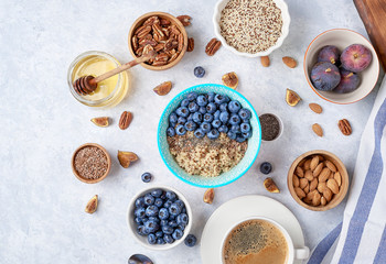 Ingredients for a healthy breakfast, quinoa with blueberry, fig, honey and nuts. Concept vegan and healthy eating. Top view