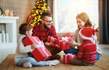 happy family   open presents on Christmas morning