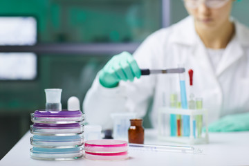 Background image of various glassware and equipment on workstation in medical laboratory, copy space
