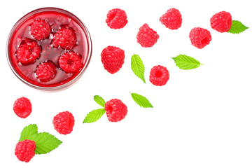 ripe raspberries with green leaves and jam isolated on white background. top view