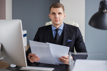 Businessman reading contract in office