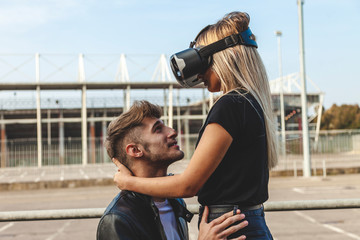 beautiful couple in love hugging with glasses of virtual reality