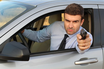 Secret agent holding gun while driving