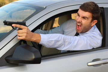 Stressed male driver yelling and holding a gun 