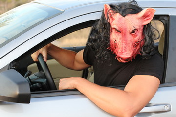 Spooky driver wearing a mask