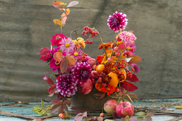 Fall flowers in bouquet, autumn composition with colorful leaves