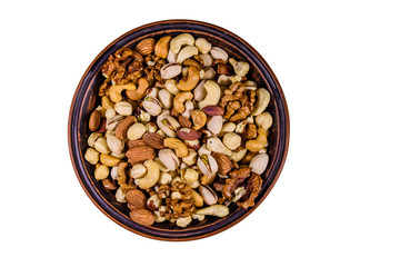 Various nuts (almond, cashew, hazelnut, pistachio, walnut) in ceramic plate isolated on a white background. Vegetarian meal. Healthy eating concept