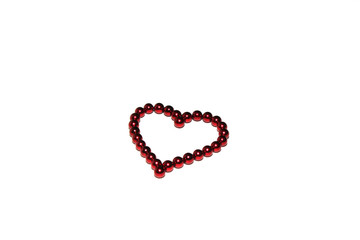 Red heart made of red magnetic beads is isolated on white background.
