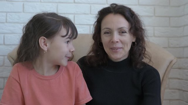 Video communication with internet link. Mother and daughter communicate on the Internet.
