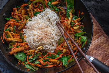 Wok with stir fried tofu and mixed vegetabels, rice noodles