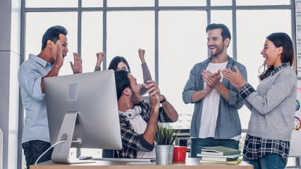 Creative director team applause for good solution of project with designer at meeting table with...