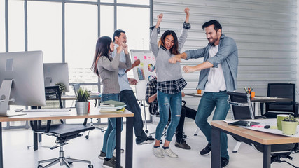 group of creative designer dancing in office with relax feeling and glad about good success news of project at modern office.business day work lifestyle.