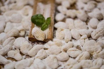 Fototapeta na wymiar Cook handmade gnocchi on the table, Italian tradition
