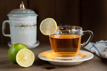 Lemon tea in a clear glass on white plate,  Lemon tea recipe