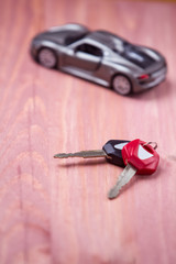 Car Loands and Credit Concepts. Car Symbol Along With bunch of Keys Against Vintage Wooden Background.