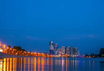 Russia. Krasnodar. River Kuban. Buildings are reflected in the river. Lights on the waterfront