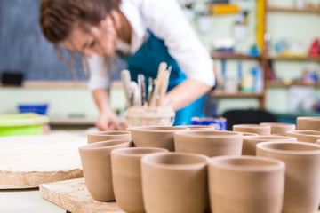 Professional Female Potter During Working Process with Clay in Workshop.