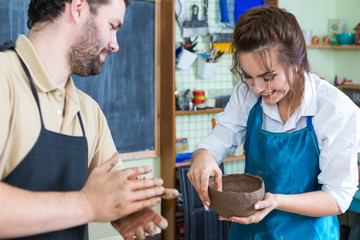 Claymaking Process Concept. Two Cheerful Professional Ceramists During a Process of Clay...