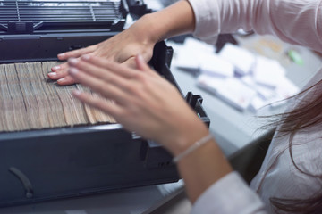 Bank employees sorting and counting money inside bank vault.