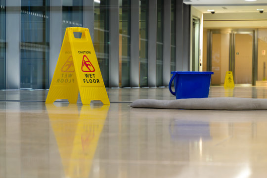 Yellow Caution Sign Showing Warning Of Slippery Wet Floor