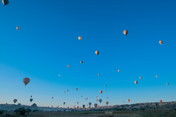 Many hot air balloons flying in Goreme, Cappadocia