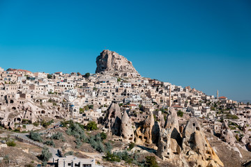 Fototapeta na wymiar Cityscape photo of Uchisar Town, Cappadocia, sky ise clean blue.