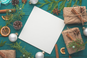 Christmas, New Year. Background with composition. On a green wooden background, greeting card with congratulation.