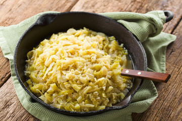 Fresh homemade braised white cabbage in cast iron skillet (Selective Focus, Focus one third into...