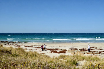 People enjoying sunny conditions at Four Mile Creek beach near St. Helens in NE Tasmania.