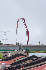 Scene view of the workers working on the construction of a highway bridge.