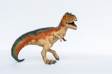 Dinosaur Toy standing on white background. Tyrannosaur rex toy
