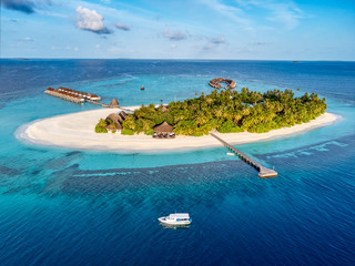 Aerial view of small resort island on sunrise.