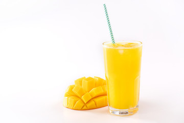 Fresh tropical mango juice with beautiful diced pulp and striped paper straw isolated on white...