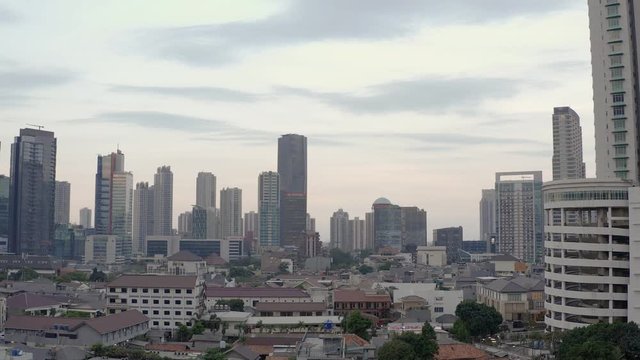 Aerial panorama view of skyline of Jakarta before sunset. dolly motion. reverse reveal. drone landing