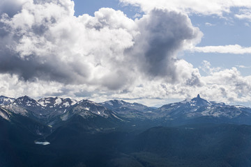 Fototapeta na wymiar blackcomb mountain peak panorama view cloudy sky summer time.