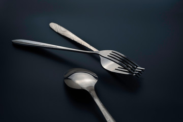Fork and spoon on dark background, Restaurant concept. soft focus in the middle.