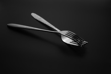 Fork and spoon on dark background, Restaurant concept. soft focus in the middle.