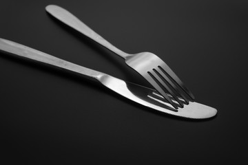 Fork and spoon on dark background, Restaurant concept. soft focus in the middle.