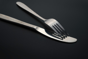 Fork and spoon on dark background, Restaurant concept. soft focus in the middle.