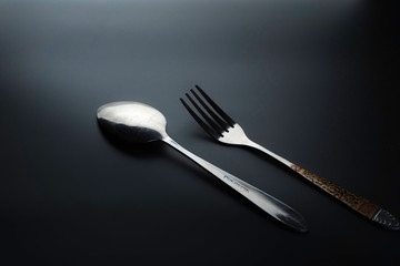 Fork and spoon on dark background, Restaurant concept. soft focus in the middle.
