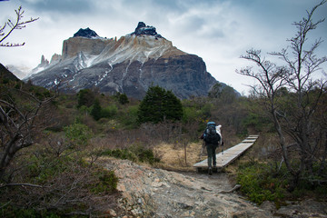 Hiker on the W trek in Torres del Paine National Park, Chile. Cuernos Mountain in the background