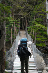 Hiker crossing Hanging Bridge in Torres del Paine National Park, Chile